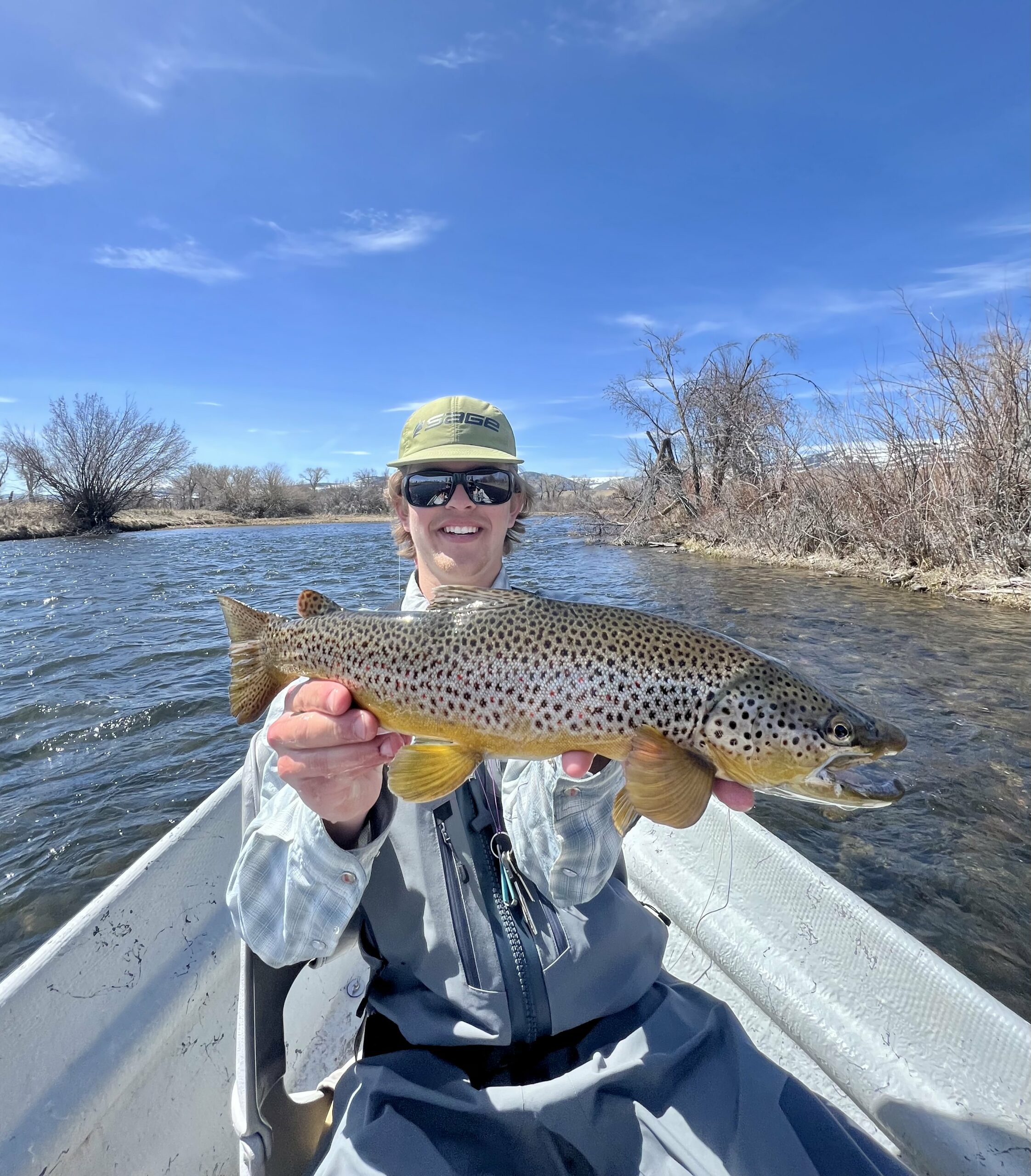 MT Trout Co Guide in drift boat holding fish