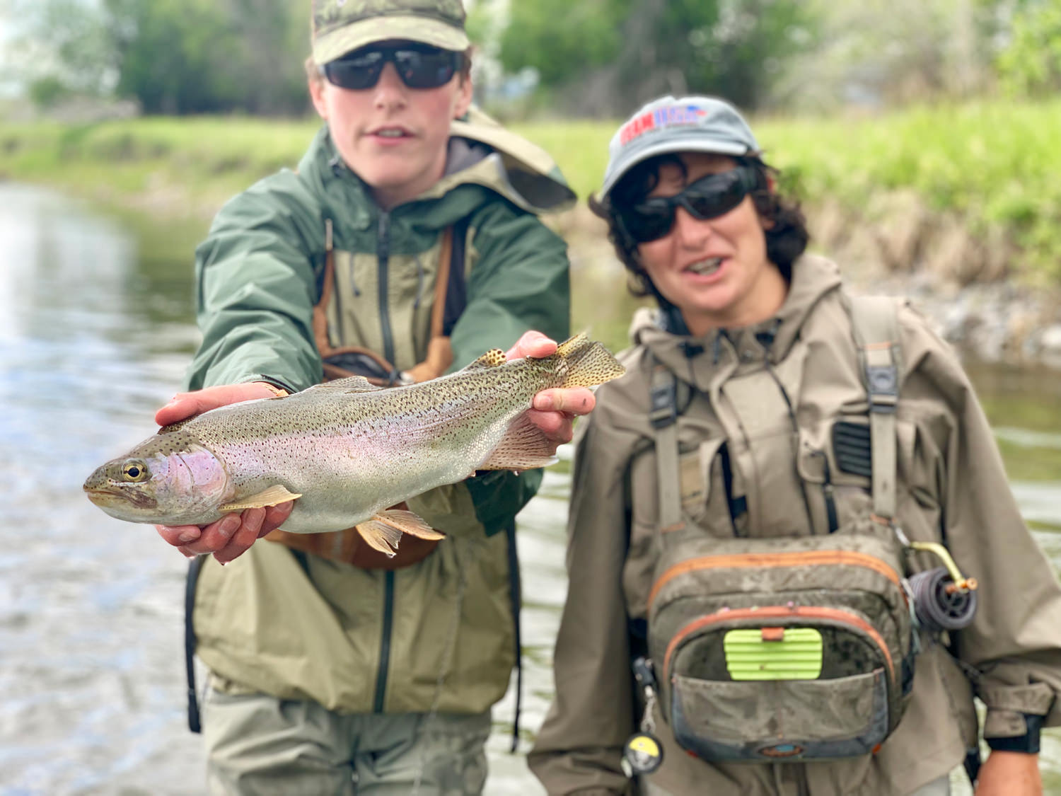 Two teenage boys with large rainbow trout