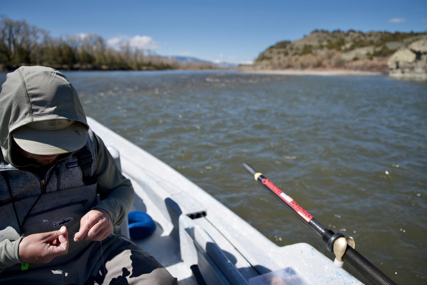 Guide tying on a fly in a driftboat