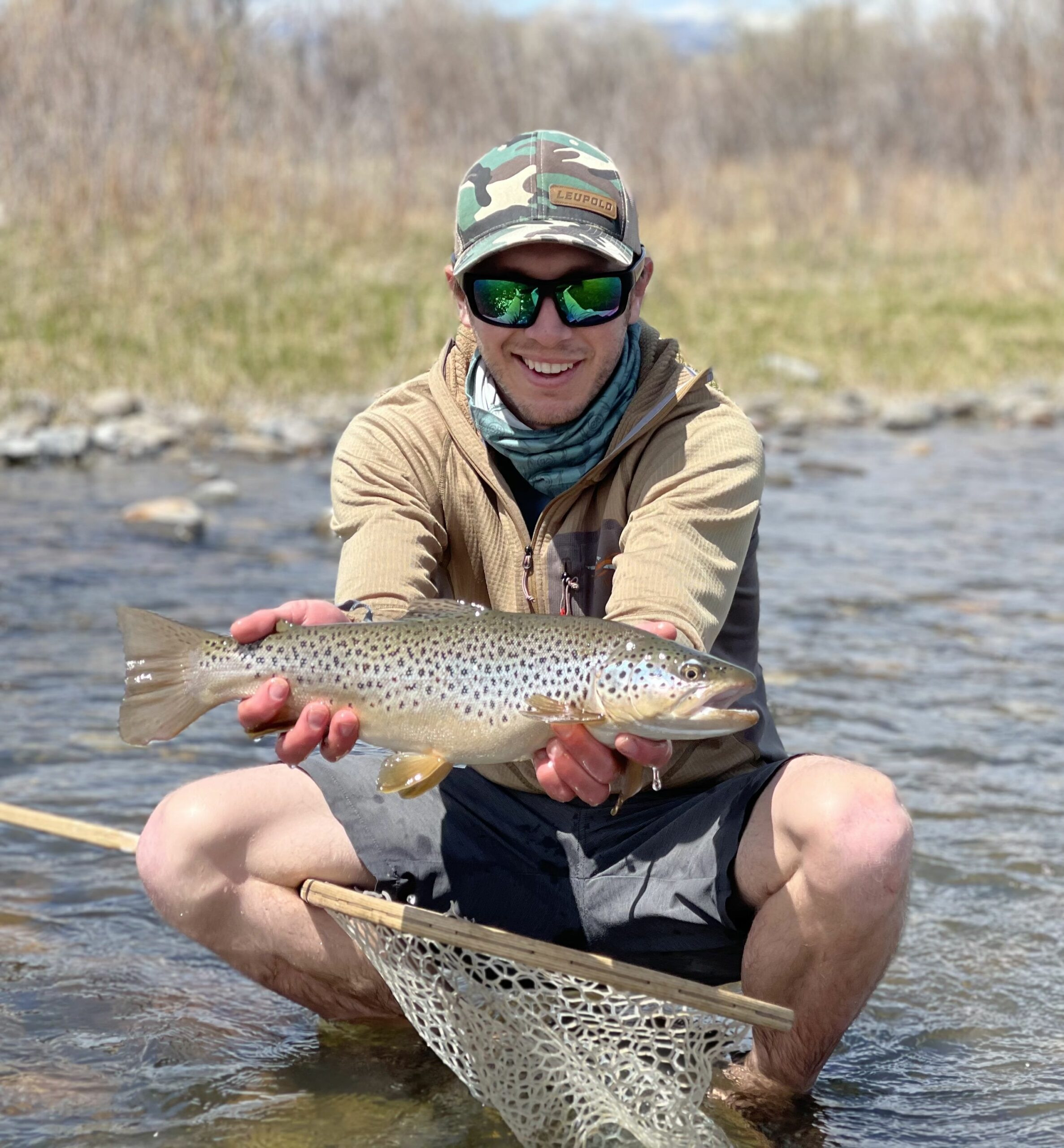 MT Trout Co guide wading, holding nice rainbow trout